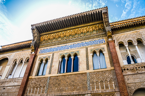 Seville, Spain - August 11, 2015: Beautiful facade within the Alcazar of Seville. Photo taken during a wam summer day, and has no people.