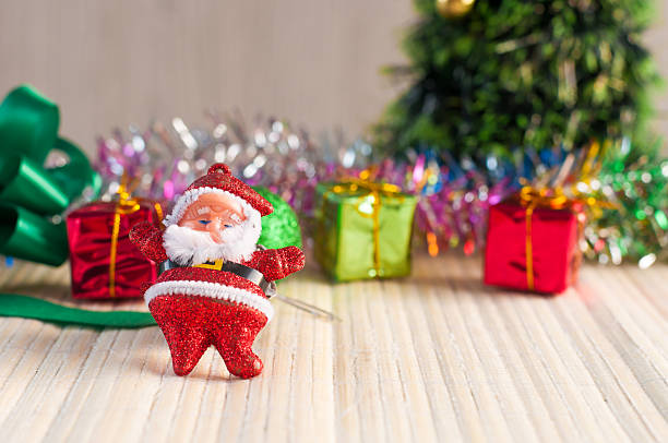 istock Santa Claus doll against a Christmas tree with gift box 495638364