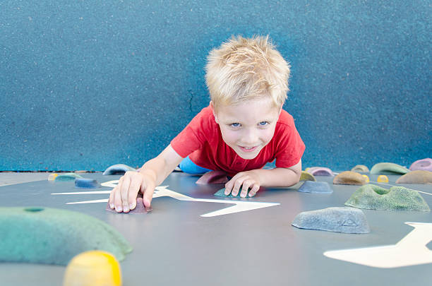istock Child on a climbing wall in a park 495645064