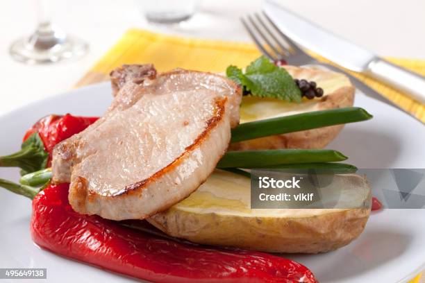 Roasted Pork Chop With Potato And Red Peppers Stock Photo - Download Image Now - 2015, Baked Potato, Close-up