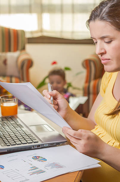 istock Pregnant mother working in home office with son 495652795