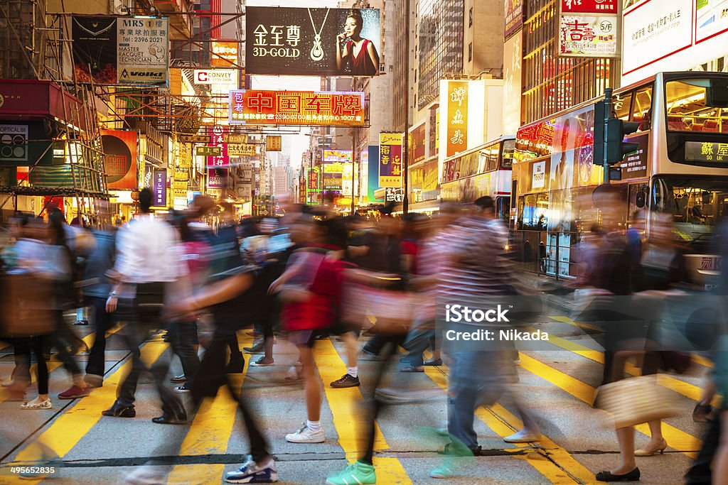 People Rushing Through Hongkong Motion Blurred Pedestrians walking over a busy crosswalk in Hong Kong China - East Asia Stock Photo