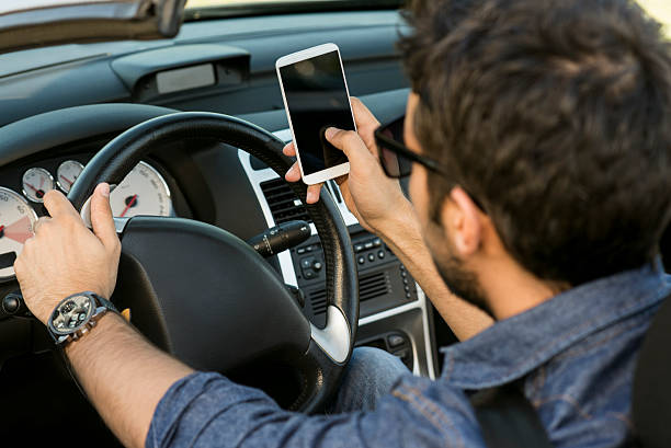 istock man typing text message in the car 495654305