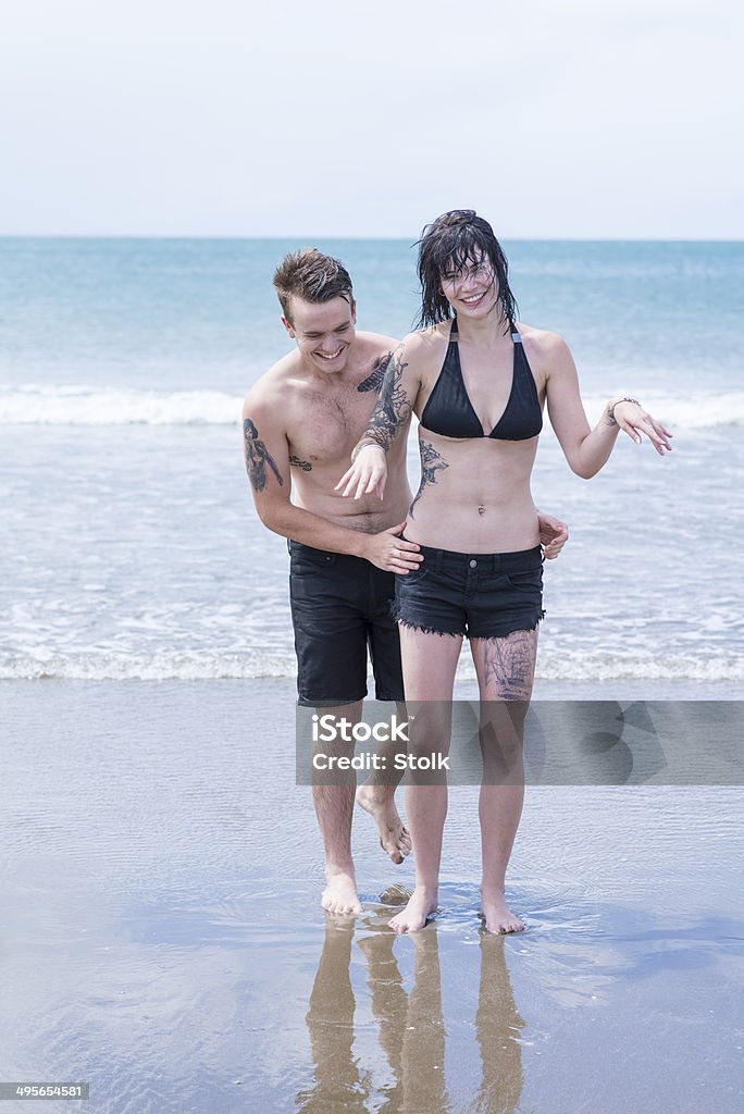 Having so much fun Two young people having fun on the beach Adult Stock Photo