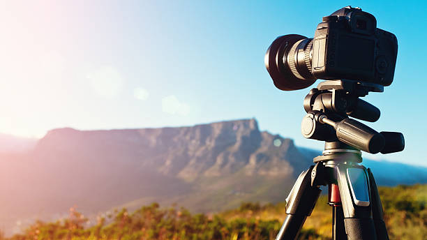 Digital SLR camera set up on a tripod to shoot a timelapse video sequence at dawn. The setting is Cape Town, South Africa, and the mountain is Table Mountain.