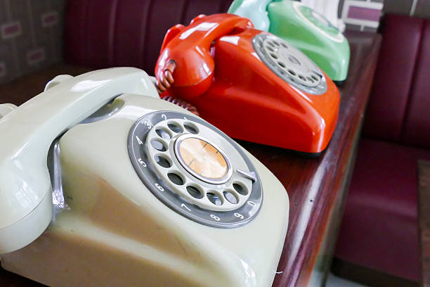 old dialling telephone old beige, red, green dialling telephone for vintage style decoration dialling phone stock pictures, royalty-free photos & images