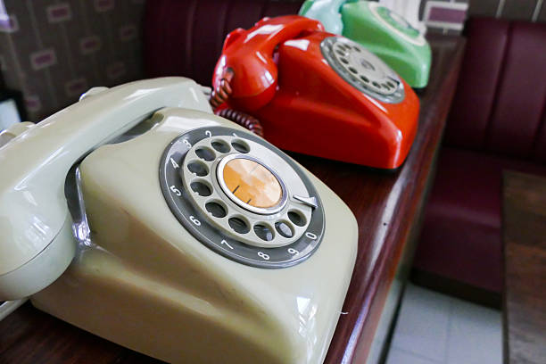 old dialling telephone old beige, red, green dialling telephone for vintage style decoration dialling phone stock pictures, royalty-free photos & images