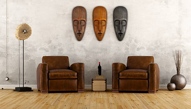 Vintage room in ethnic style with two leather armchair and african masks on wall - 3D Rendering