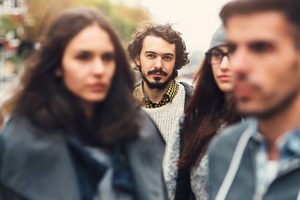 Crowd A man looking through a crowd of people. group of people staring stock pictures, royalty-free photos & images