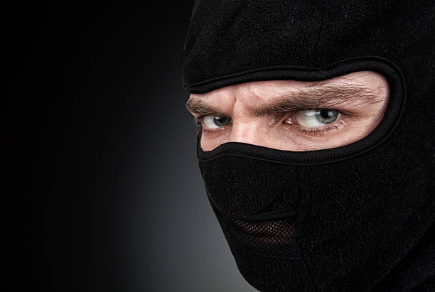 istock Man in a mask on black background 495666153