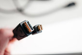 Hand holding Mini DisplayPort and DisplayPort cables