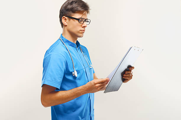 istock Doctor With Clipboard Against Grey Background 495670006