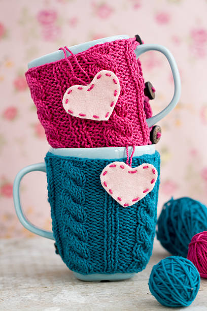 istock Two blue cups in blue and pink sweater with hearts 495670214