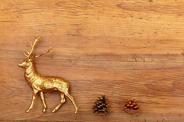 istock Deer figure and cones on wood 495670304