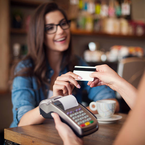 istock Woman paying with credit card at cafe 495671603