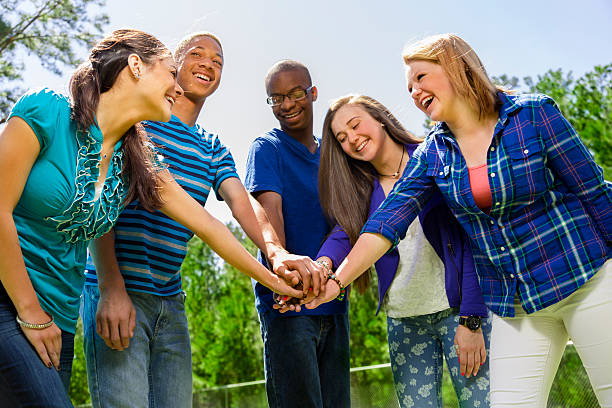 istock All for one! Teens showing unity, a helping hand. 495671733