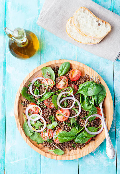 istock Lentil salad with cherry tomatoes, red onion and baby spinach. 495672200