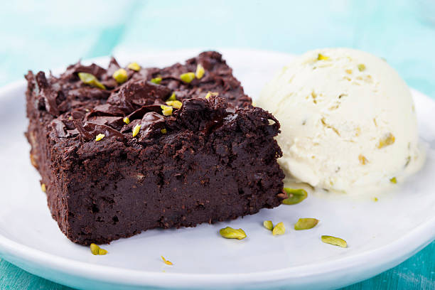 istock Chocolate brownie, cake, white plate on a turquoise wooden background 495672430