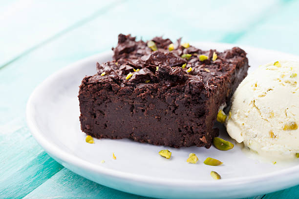 istock Chocolate brownie, cake, white plate on a turquoise wooden background 495672552