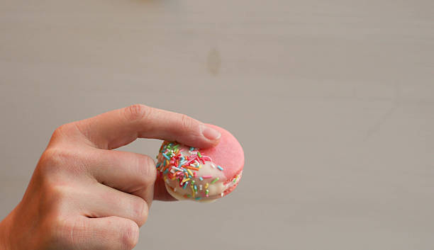 istock Chocolate Dipped Pink Macaroons with Berries Buttercream and Sprinkles 495674064