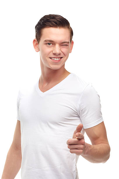 You got it! A cropped portrait of a confident young man pointing, isolated on white young man wink stock pictures, royalty-free photos & images