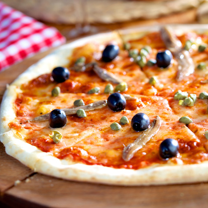 Delicious pizza with anchovies, capers and black olives