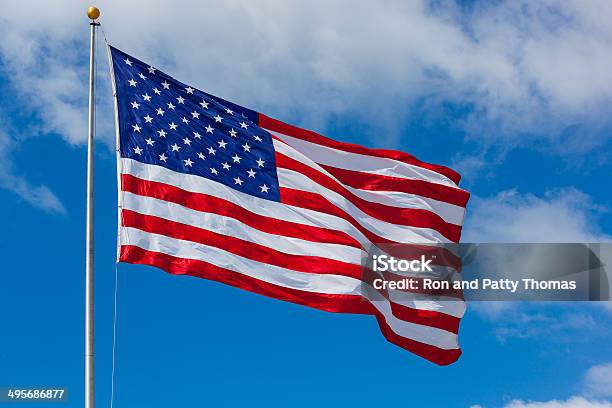 American Flag Against The Sky Stock Photo - Download Image Now - American Flag, Flying, Mid-Air