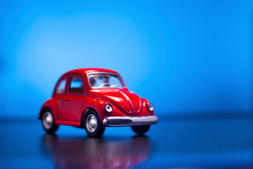 İzmir, Turkey - May 20, 2014: Toy Volkswagen Beetle, shooted blue colored background, macro shot.