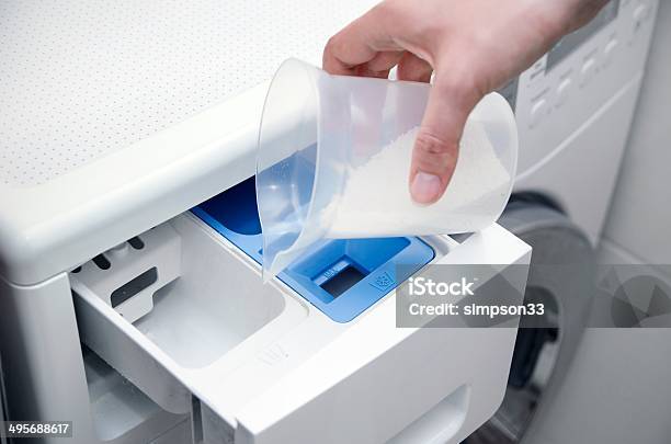 Woman Hand Pouring Washing Powder Into The Washing Machine Stock Photo - Download Image Now