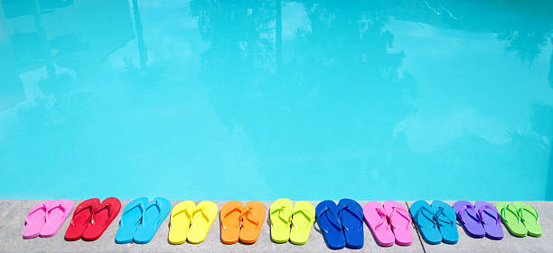 Color flip flops by the pool stock photo