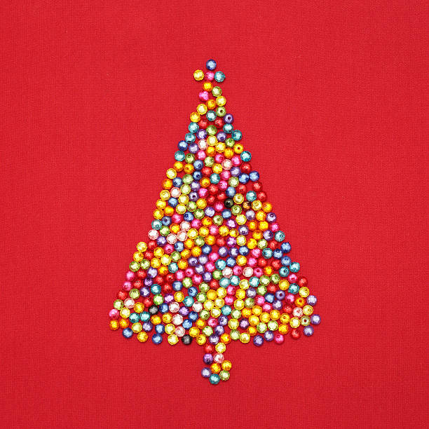 istock Christmas tree decorate by colorful beads on red background 495691007