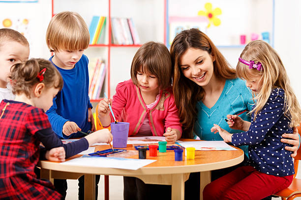 istock Group Of Elementary Age Children In Art Class With Teacher 495691855