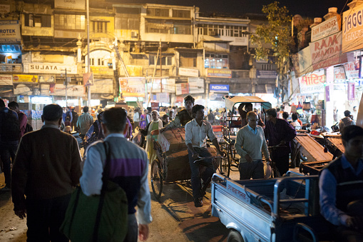 A view of a crowded Delhi market square at night, New Delhi, India