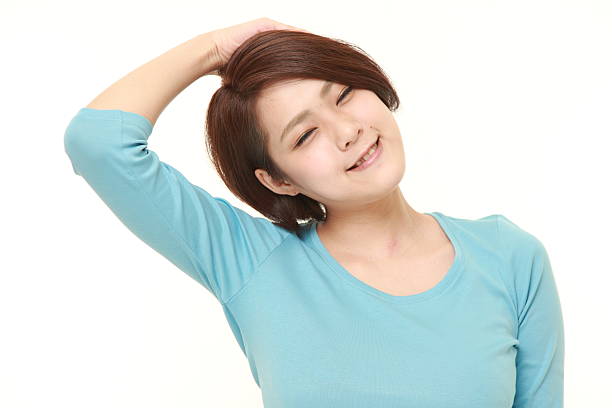istock young woman doing self neck stretch 495692266