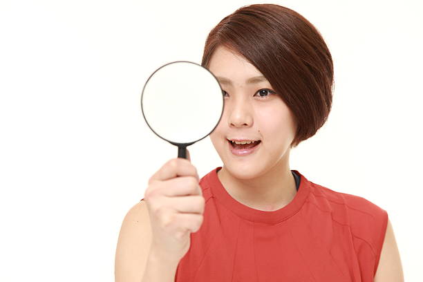istock Japanese woman with a magnifying glass 495694314
