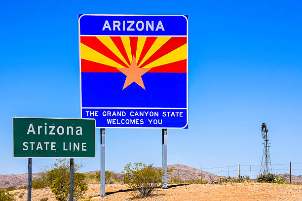 istock Arizona State Line Welcome Sign with windmill, mountains, and sky 495696107