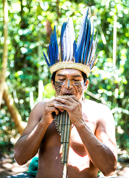 istock Native Brazilian playing wooden flute 495697126