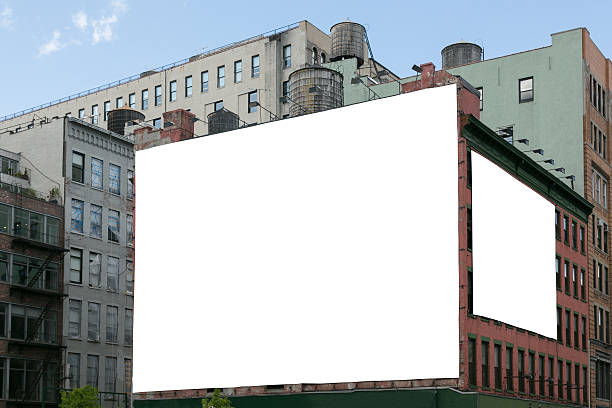 Two white blank billboard on the brick wall building. stock photo