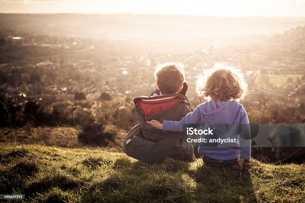 Brother and Sister Young siblings overlook a city from a hill. Brother Stock Photo