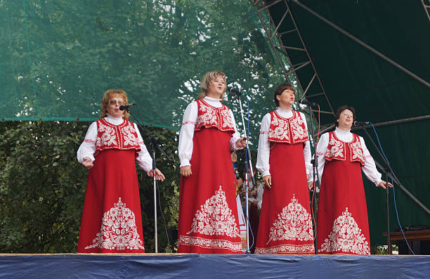 Day of the city Mstera in Russia Mstera,Russia-August 16,2014: Group of the womans in national suit sing on scene under opened by sky at day of the city Mstera,Russia jason day actor stock pictures, royalty-free photos & images