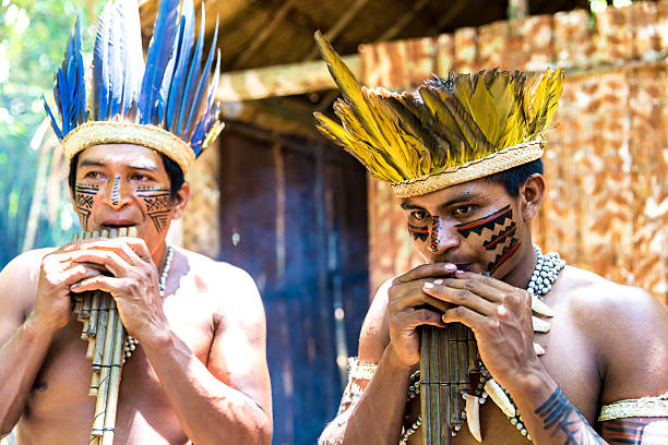 istock Native Brazilian men playing wooden flute 495698104