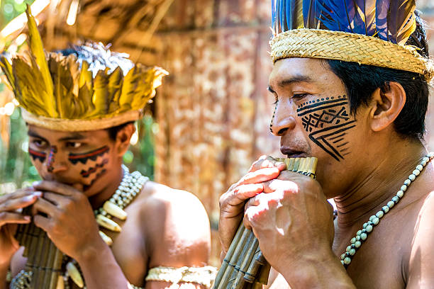 istock Native Brazilian men playing wooden flute 495698140