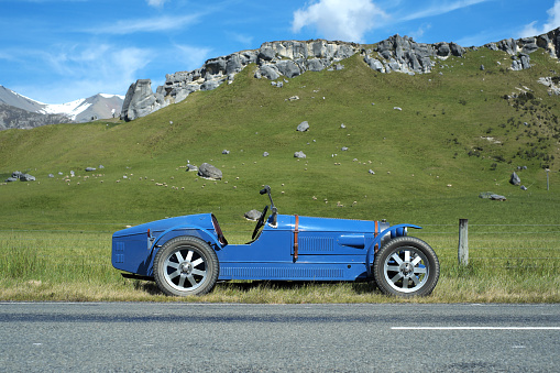Canterbury, New Zealand - December 13, 2012: Summer sunshine falls on an Acorn, a replica of a 1927 Type 35 Bugatti, as it sits on the road running through Arthur's Pass National Park, on New Zealand's South Island.