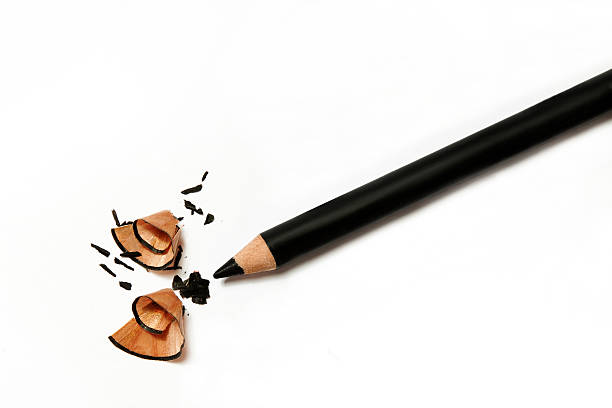 still life make up. black eye pencil tempered on white background. black eye pencil's chips
