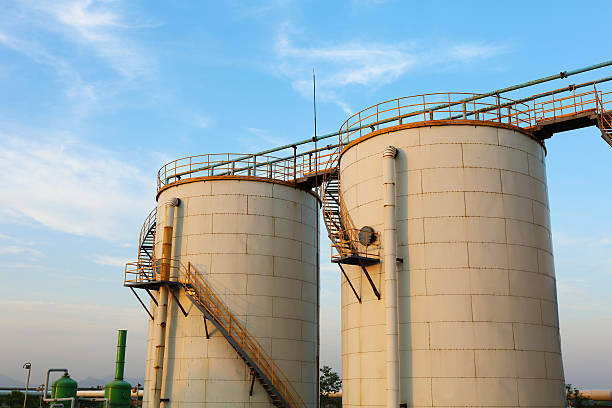 istock Low-angle shot of ladder and tanks refinery. 495698411
