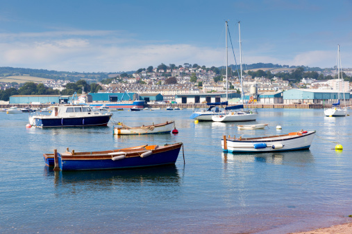 Boats on Teign river Teignmouth Devon tourist town with blue sky a colourful traditional English coastal scene