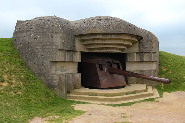 istock Old broken German bunkers of Atlantic Wall and artillery battery 495702141