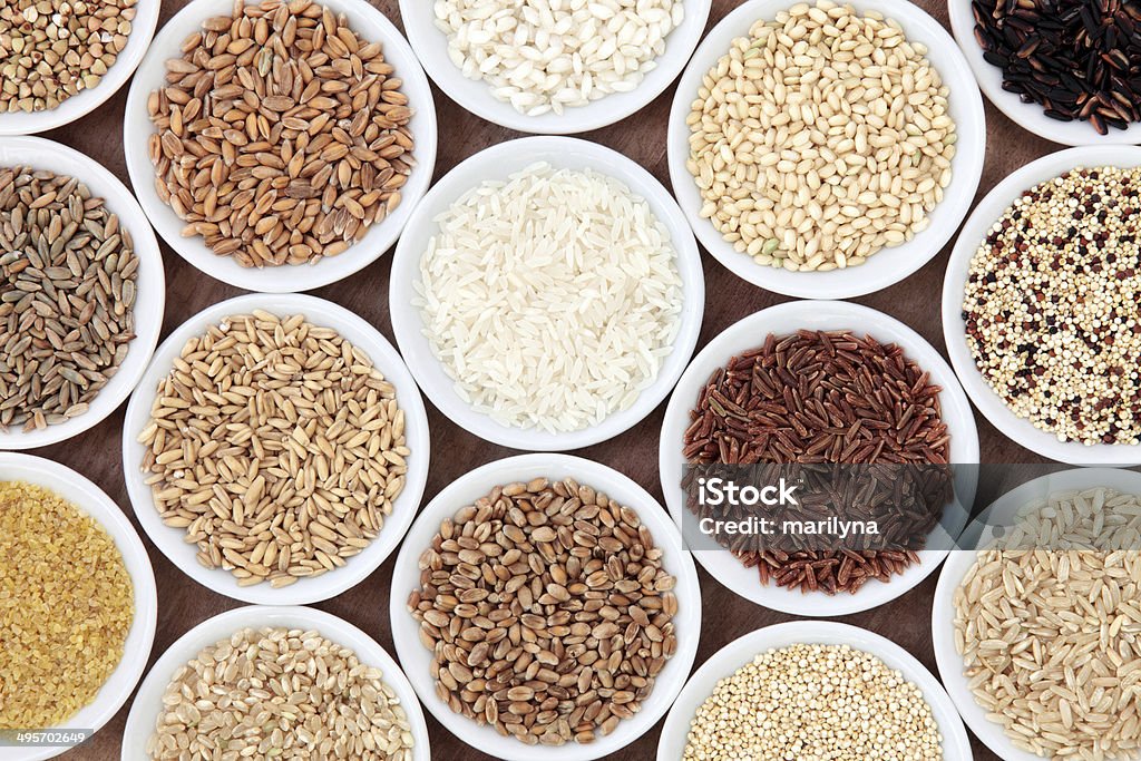 Grain and Cereal Selection Grain and cereal food selection in white porcelain bowls over white backgroun Antioxidant Stock Photo