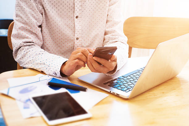 istock Businessman using laptop and telephone 495704784