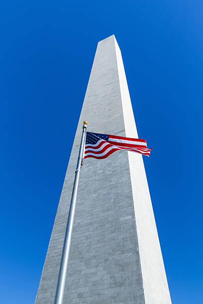 istock Washington, DC - US flag in front of Washington Monument 495714723